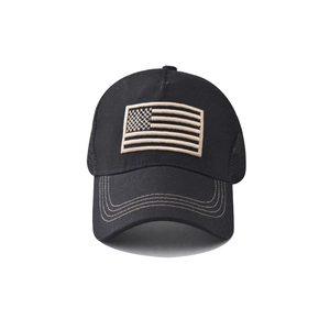 Detailed close-up of American flag embroidery on a black washed cotton baseball cap