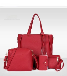 Macro shot of 4-piece red litchi pattern bag set featuring tote and golden hardware