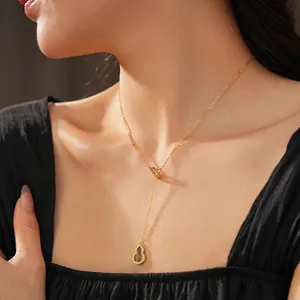 Adjustable golden Y-shaped necklace featuring zircon-encrusted gourd pendants on model