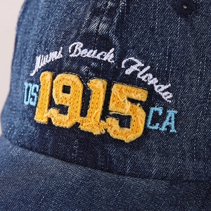 Close-up of vintage denim baseball cap with 1915 Miami Beach Florida embroidery details