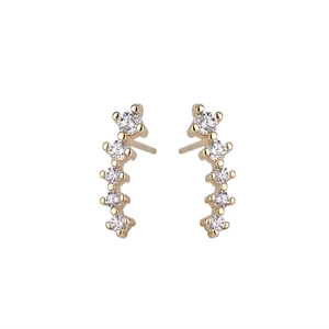 Close-up of minimalist gold curved stud earrings with five sparkling cubic zirconia stones