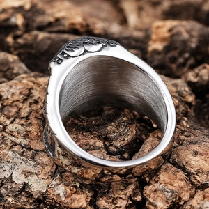Vintage Thor's Hammer Viking ring in stainless steel displayed on a natural tree bark