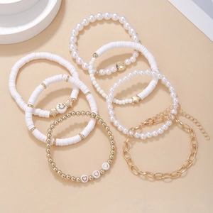 Bohemian multilayer bracelet set with white clay beads, pearls, and gold charms