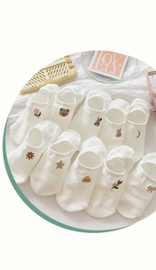 Detail of ten pairs of white cotton invisible boat socks with cute cartoon embroidery