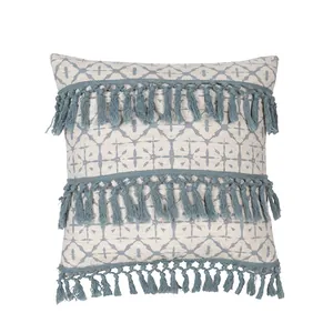 Close-up of bohemian blue geometric pattern pillow cover with three rows of decorative tassels