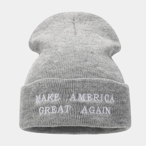 Close-up of white embroidery text on a grey knitted beanie for men and women