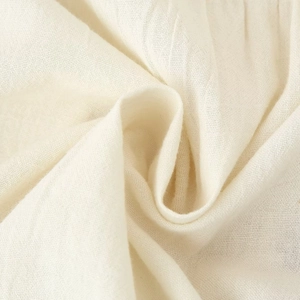 Close-up of beige linen fabric texture with embroidery for ethnic style women top