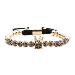 Detailed view of woven crown bracelet with blue cubic zirconia and gold beads