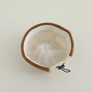 Detail of baby knit docker hat showing brown knit exterior and corduroy lining