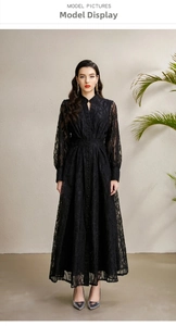 Macro detail of intricate lace embroidery and tiered skirt on a black V-neck maxi dress