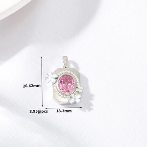Macro shot showing dimensions of floral silver pendant with pink stone and pearls