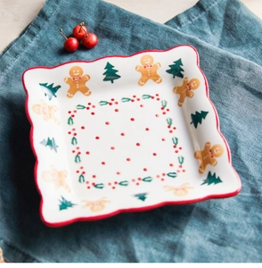 Detail of square ceramic Christmas plate with gingerbread man and red wavy edge