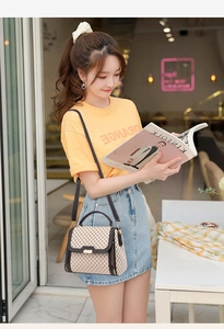 Chic beige crossbody bag with brown grid pattern shown in a stylish lifestyle setting