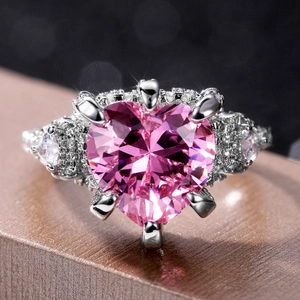 Luxurious pink heart-cut zircon ring with micro-paved crystals on silver band