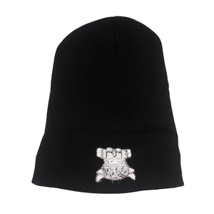 Detail of black knit beanie featuring white embroidered highland cow cartoon pattern