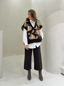 Retro V-neck knitted vest with abstract jacquard pattern layered over a white shirt