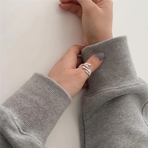 Close-up of irregular 925 sterling silver ring showing molten texture on model finger