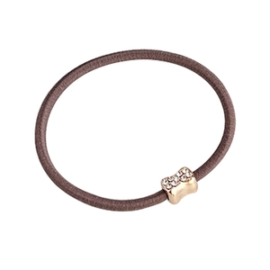 Brown elastic hair tie with a gold bone-shaped metal buckle and sparkling rhinestones