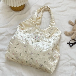 Detail of bear print silk shoulder bag with velvet texture in cozy aesthetic setting