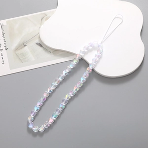Macro detail of holographic heart beads on a short wrist strap for mobile phone