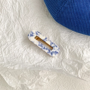 Detailed macro view of the rectangular hair claw clip with blue and white marble texture