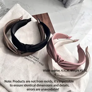 Elegant knotted satin headbands in four colors shown from a 45-degree angle view
