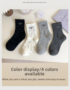 Close-up of four colors of long-staple cotton socks with polka dots and bow patterns
