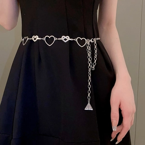 Detail view of silver heart-shaped waist chain with hollow links and triangle pendant