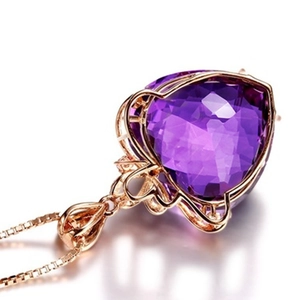 Macro detail of heart-cut amethyst pendant with rose gold filigree and matching box chain