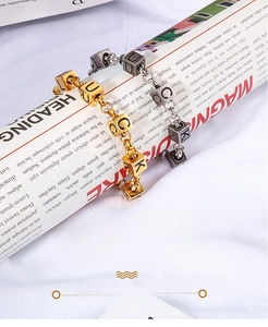 Detail showing gold and silver titanium Lucky letter square beads on link chains