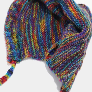 Close-up of colorful chunky knit texture and soft lining on the vintage winter earflap hat