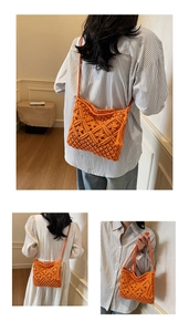 Close-up of orange handmade woven shoulder bag featuring bohemian fringe and zipper closure
