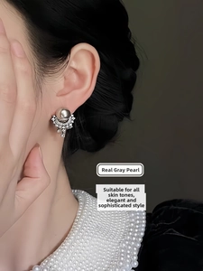 Macro shot of Zhenduoma grey pearl earrings with vintage silver texture on model