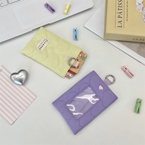 Detailed close-up of quilted heart card holders in mint green and lavender purple with hooks
