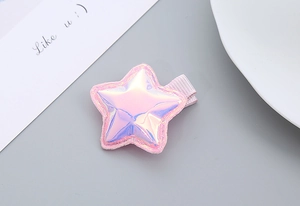 Detail of pink iridescent star hair clip with fine stitching and wrapped metal base