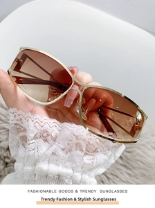 Detail of golden metal frame sunglasses with light brown gradient lenses for Y2K style