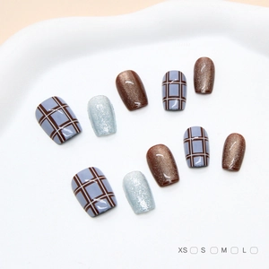Handmade press-on nails with blue brown plaid patterns and cat-eye glitter finish
