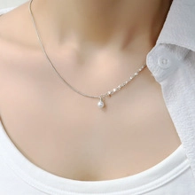 Detailed view of elegant silver lily of the valley pearl pendant necklace on a model