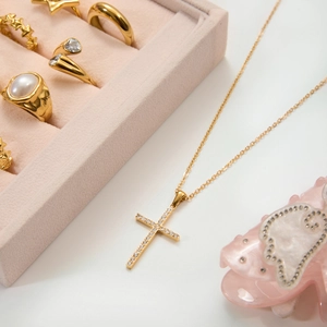 Elegant 18K gold plated stainless steel cross necklace with zircon stones on white background