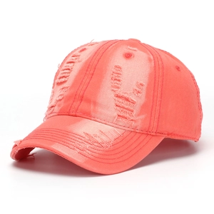 Detail of distressed coral pink washed denim baseball cap with vintage frayed hole design