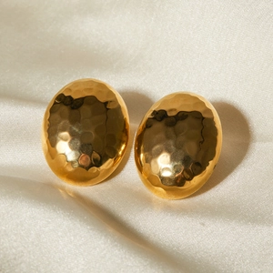 Detailed view of 18k gold plated stainless steel oval earrings with hammered texture