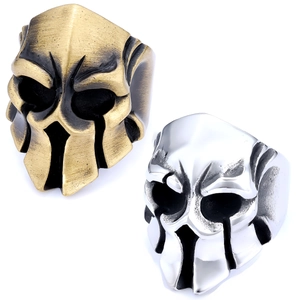 Detailed macro view of vintage Spartan helmet rings in silver and bronze metallic finishes