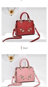 Detail view of embroidered floral handbags with scalloped edges and heart metal charms
