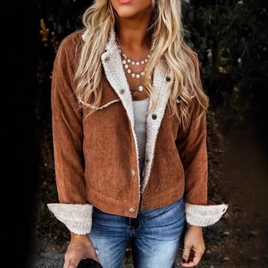Detail of vintage brown corduroy jacket with white fleece lining and metal buttons