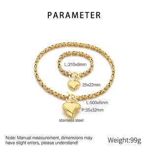 Detailed view of golden Byzantine chain jewelry set with hollow heart pendants and OT clasps