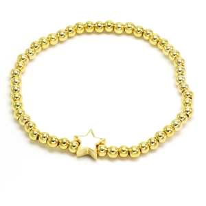Detailed view of gold beaded bracelet featuring a white enamel star pendant on white background