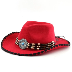 Detail of red wool felt cowboy hat featuring turquoise buckle and beaded band