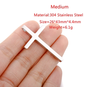 Detailed view of hand-held 304 stainless steel cross pendant with polished silver finish