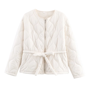 Detail of diamond-quilted cream cotton jacket with adjustable drawstring waist and zip closure
