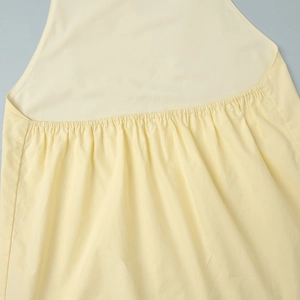 Détail de la taille élastiquée froncée sur l'ensemble haut dos nu et pantalon jaune clair
